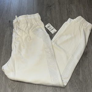 White sweatpants with rhinestones on sides